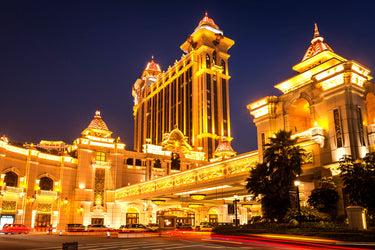 Image of the Galaxy Resort Macau in its brilliance, lighting the night sky.