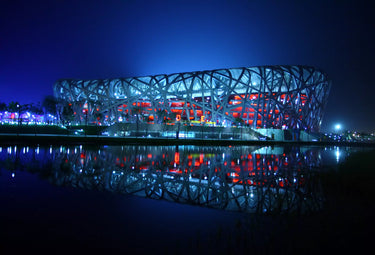 The 2008 Beijing Olympic Stadium at night featuring some of the most innovative facade lighting of its era.