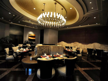 Chandelier lighting a restaurant/eating area.